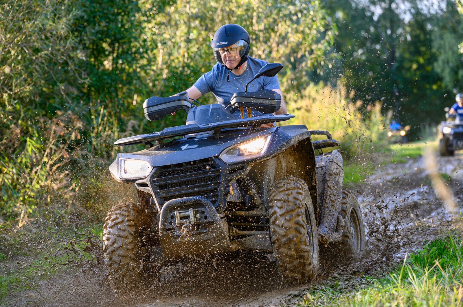 Mężczyzna jadący na quadzie podczas pełnej emocji przeprawy w terenie