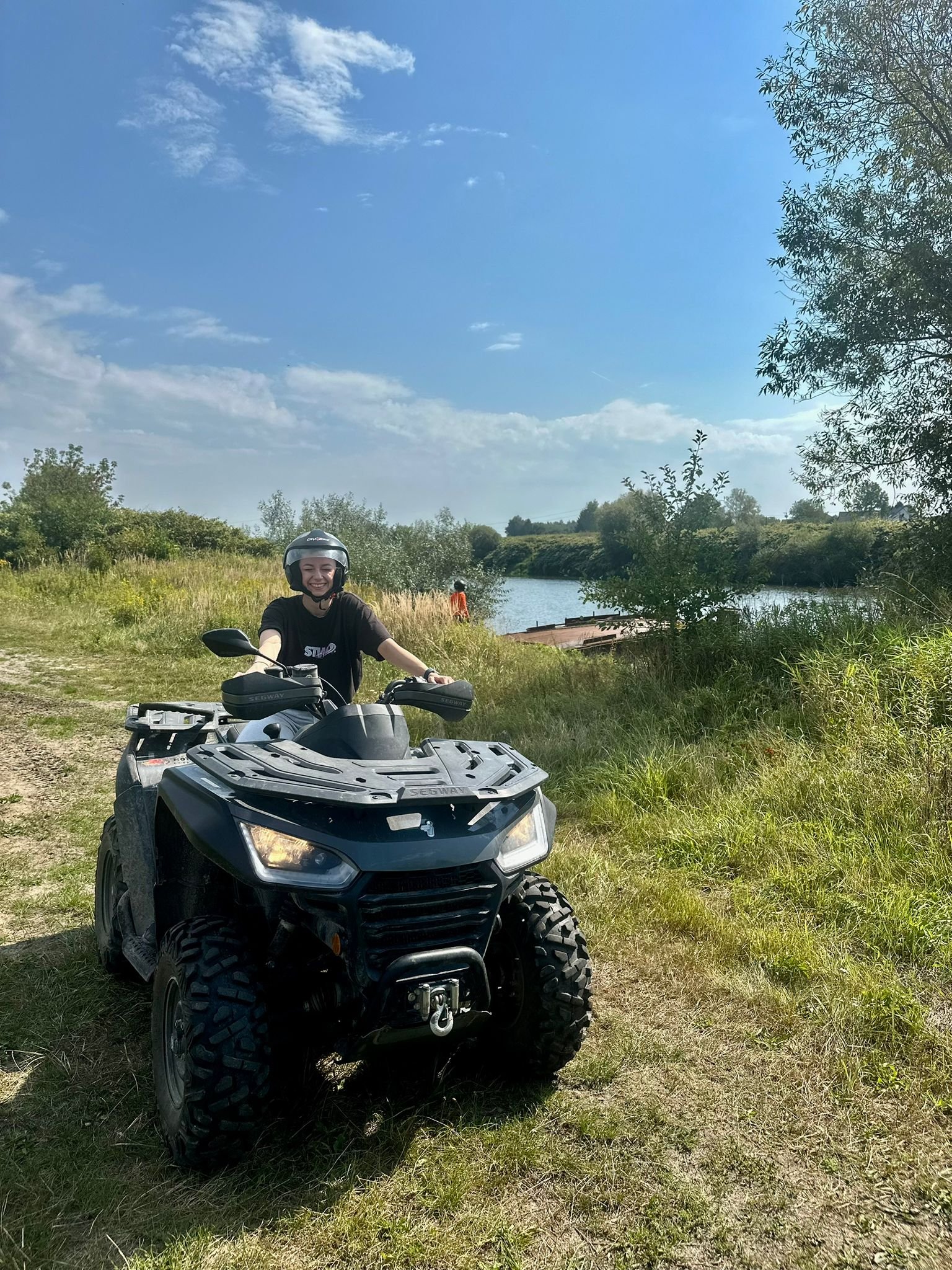 Zadowolony uczestnik wyprawy offroadowej siedzący na quadzie